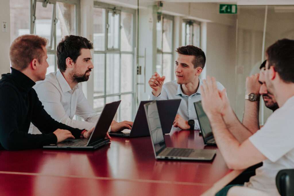Picture of Scoptvision founders and other team members working at a table